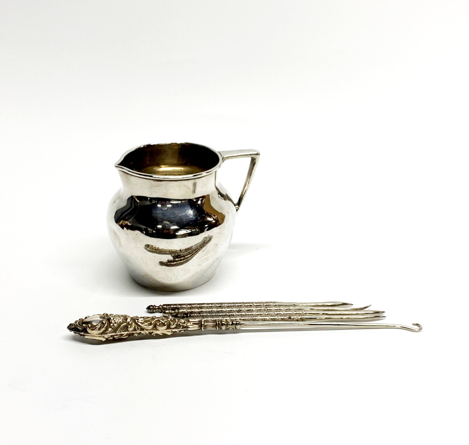 A hallmarked silver milk jug with a silver plated basket inliner, three napkin rings and other - Image 2 of 3
