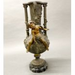 A 19th century French Art Nouveau spelter cherub vase on a black and green marble base, H. 44cm.