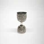 An Eastern hammered white metal (tested silver) hen and duck egg cup, H. 10cm.