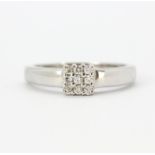 An 18ct white gold cluster ring set with brilliant cut diamonds, (O).