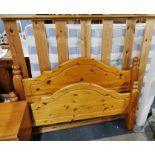 A pine double bed frame, headboard and four under bed sliding drawers on wheels, together with a