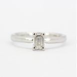 An 18ct white gold solitaire ring set with a baguette cut diamond, approx. 0.57ct, colour G, clarity