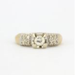 An 18ct yellow gold rin set with a brilliant cut diamond and diamond set shoulders, (J).