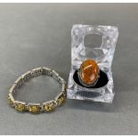 A silver and amber ring with a silver and amber bracelet.