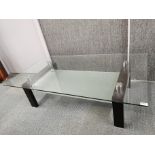 A modern glass and metal coffee table with frosted glass under layer, 140 x 80 x 40cm.