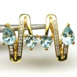 A pair of gold on 925 silver earings set with trillion cut blue topaz and white stones, L. 1.9cm.