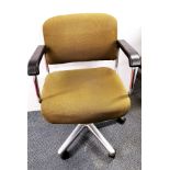 An upholstered and metal swivel desk chair.