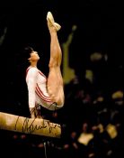 Gymnast Nadia Comaneci Handsigned 10x8 Colour Photo. Photo shows Comaneci Competing in her Younger