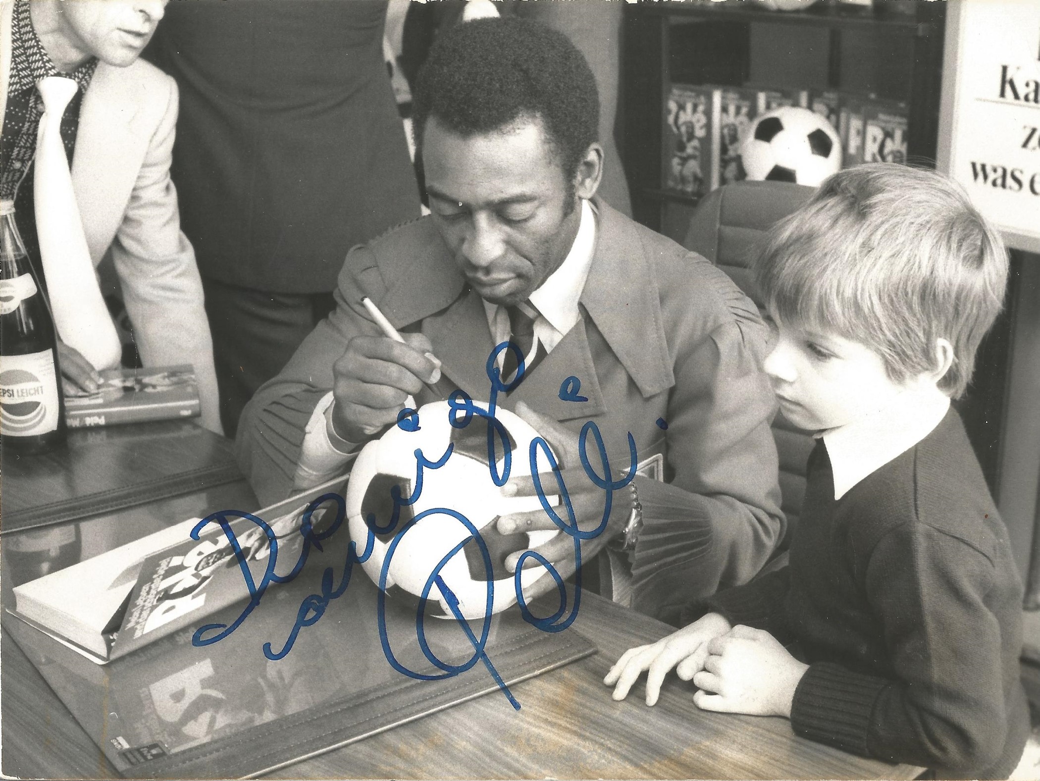 Football legend Pele signed nice vintage 8 x 6 inch black and white photo, signing a football for
