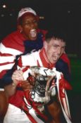 Football. Andy Linighan Signed 12x8 colour photo. Photo shows Linighan Lifting the Challenge