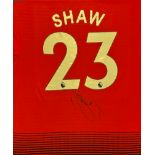 Football Luke Shaw signed Manchester United number 23 replica shirt mounted to a board. Luke Paul