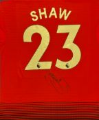 Football Luke Shaw signed Manchester United number 23 replica shirt mounted to a board. Luke Paul