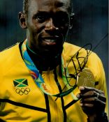 Athletics Legend Usain Bolt Hand signed 10x8 Colour Photo showing bolt proudly showing off his