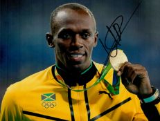 Athletics Legend Usain Bolt Hand signed 10x8 Colour Photo showing bolt proudly showing off his