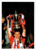 Man Utd Legend Bryan Robson Hand signed 16x12 Print showing Robson holding aloft the European Cup.