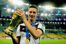 Football, Julian Draxler signed 12x8 colour photograph pictured holding the 2014 FIFA World Cup