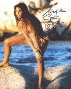 007 Bond girl Caroline Munro signed sexy pose 8x10 photo. Good condition. All autographs come with a