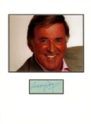 Terry Wogan signature piece mounted below colour photo. Approx size 16x12. 3 August 1938 - 31