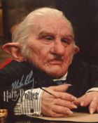 Harry Potter 8x10 movie photo signed by Michael Henbury as Gringot's Goblin. Good condition. All