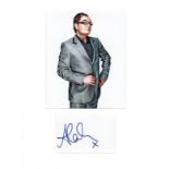 Alan Carr signature piece mounted below colour photo. Approx size 16x12. English comedian,