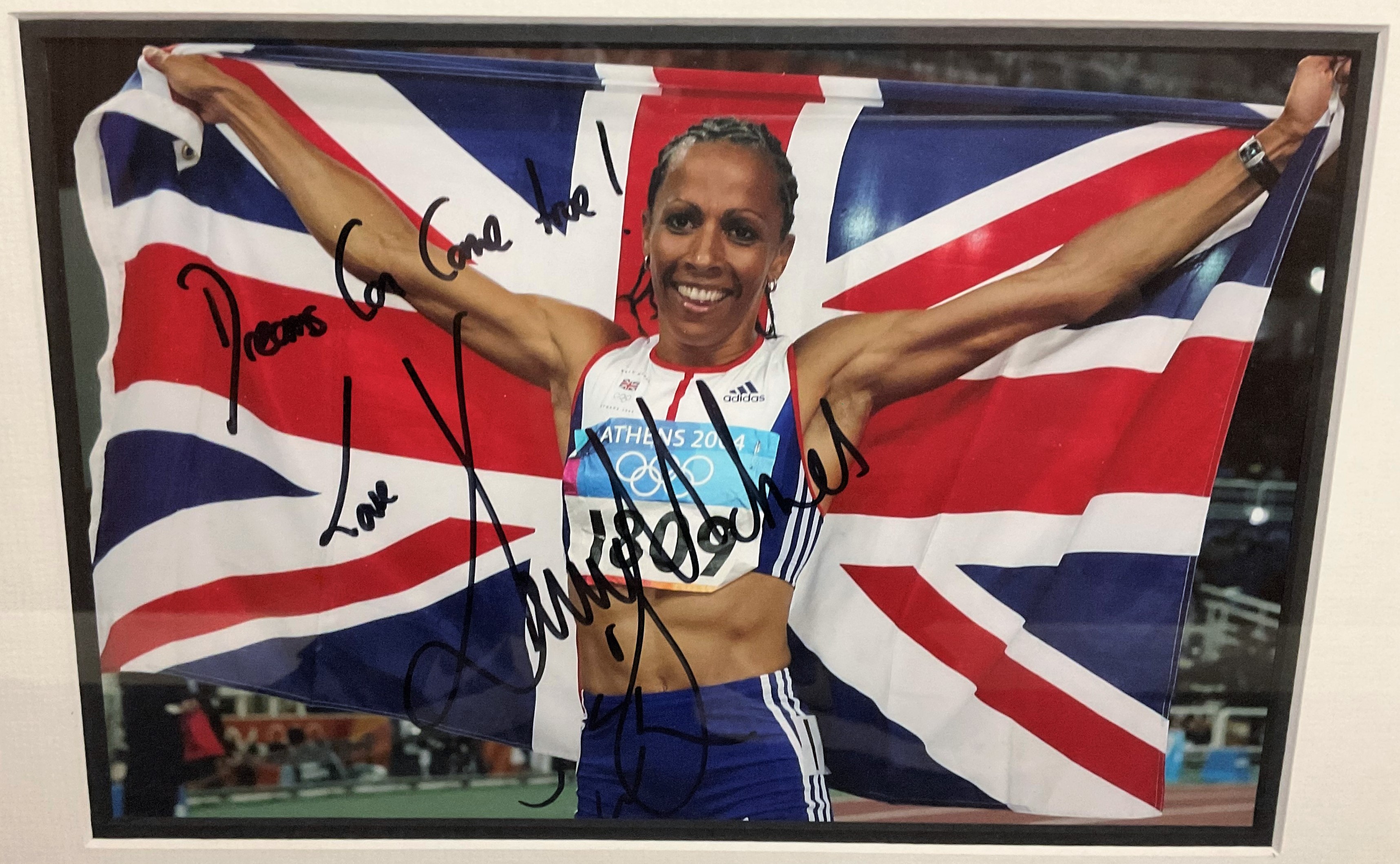 Dame Kelly Holmes Hand signed 12x8 Colour Photo of Holmes after winning two Gold Medals in Athens in