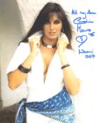 007 Bond girl Caroline Munro signed sexy pose 8x10 photo. Good condition. All autographs come with a