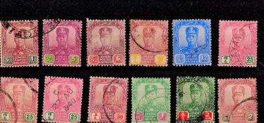 Johore Pre 1936 12 Stamps On Stockcard. Good condition. We combine postage on multiple winning
