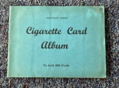 Cigarette card collection in album. Includes 1938 speed, 1936 national flags and emblems. 1938