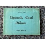 Cigarette card collection in album. Includes 1938 speed, 1936 national flags and emblems. 1938