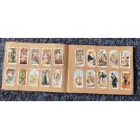 Cigarette card collection in album. Includes Dandies 1932, Butterflies 1932, Wildflowers 1939 and