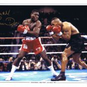 Autographed FRANK BRUNO 16 x 12 Edition - Col, depicting FRANK BRUNO swinging a left hook at a
