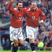 Autographed RYAN GIGGS 16 x 12 photo - Col, depicting Manchester United's RYAN GIGGS celebrating his