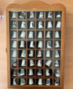 Collection of 48 China UK PLACES Thimbles in presentation box. Box has a working door with plastic