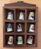 Snow White and the Seven Dwarfs Bone China Thimbles Set of 8. Set within a wooden cubicle display