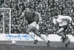 Autographed TREVOR BROOKING 12 x 8 photo - B/W, depicting a superb image showing the West Ham United