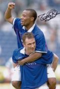 Autographed ROD WALLACE 12 x 8 photo - Col, depicting the Rangers centre-forward celebrating with