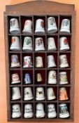 Collection of 30 Thimbles set within a wooden display shelf. 29 fine bone China thimbles and 1
