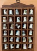 Collection of 30 UK based Thimbles in wooden display shelf. Collection is predominantly Cornwall