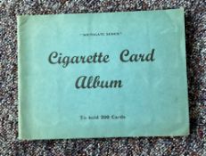 Cigarette card collection in album. Includes Dandies 1932, Butterflies 1932, Wildflowers 1939 and
