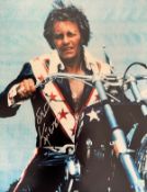 Evel Knievel 20x16 signed colour print pictured sitting on his motorcycle. Robert Craig Knievel (