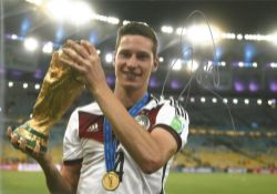 Football, Julian Draxler signed 12x8 colour photograph pictured holding the 2014 FIFA World Cup