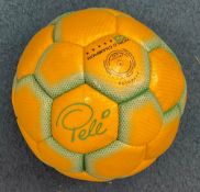 A yellow and green Café Pelé football owned by Pelé. The ball features Peles faux signature in