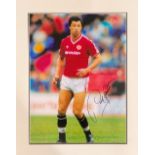 Paul McGrath signed 19x15 mounted colour photo pictured in action for Manchester United. Good