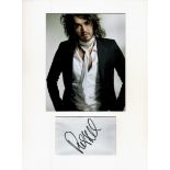 Russell Brand signature piece mounted below colour photo. Approx size 16x12. Good condition. All