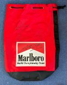 Formula One Drivers, Michael Schumacher and Eddie Irvine signed red Duffle bag. This lovely bag sits