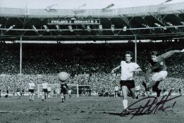 Football Legend, Geoff Hurst signed 12x8 black and white photograph pictured during an iconic moment