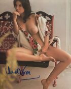 007 Bond girl Lana Wood signed photo, desirable image of her reclining topless in a chair. Good