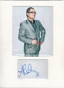 Alan Carr signature piece mounted below colour photo. Approx size 16x12. English comedian,