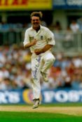 Phil Tufnell signed 12x8 colour photo pictured while playing Test Match cricket for England.