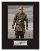 Vikings Travis Fimmel hand signed professionally mounted display. This beautiful display consists of